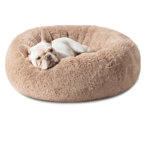 French Bulldog resting on a soft, plush calming dog bed in beige colour.