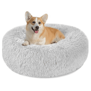 Corgi resting comfortably in a soft, gray Nepfaivy calming dog bed for anxiety relief.