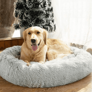 Large golden retriever relaxing in a soft, plush SAVFOX calming dog bed by a window.