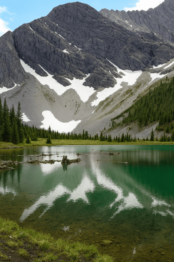 Running Rain Lake trail with scenic mountain backdrop and forest hiking path in Kananaskis Country Alberta