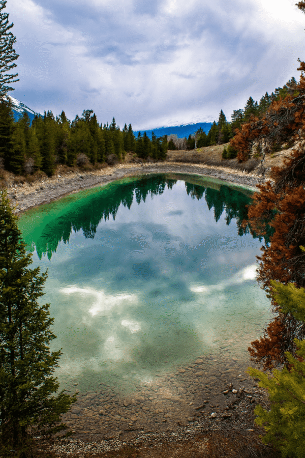 Saturday Night Lake Loop trail with hikers on scenic mountain path through forest in Jasper National Park Alberta
